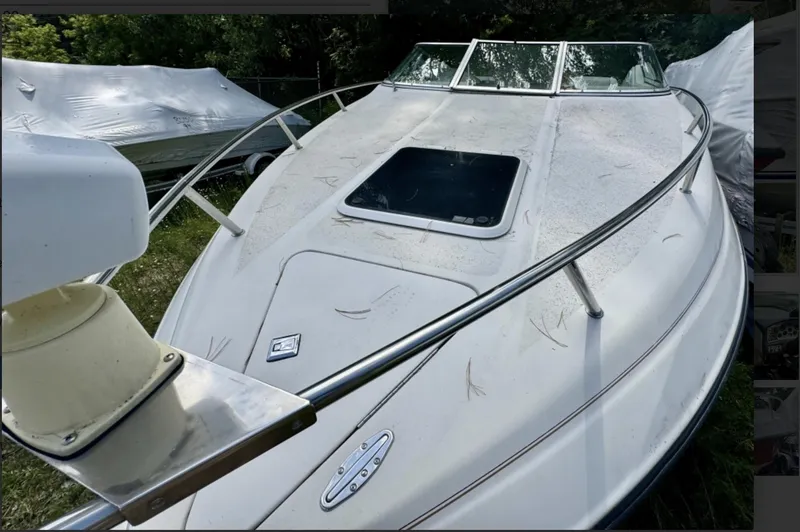 Slide: The Image of 1992 Crownline 210 CCR boat with white exterior, docked outdoors. - 4