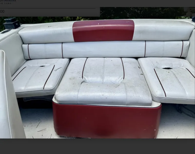 Slide: The Image of 1992 Crownline 210 CCR boat interior with red and white seating, showing wear and tear. - 7