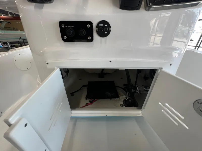 Slide: The Image of 2025 NauticStar 194 Bay boat console with open storage compartment. - 11