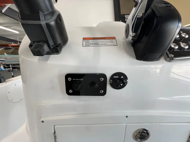 Slide: The Image of Control panel of 2025 NauticStar 194 Bay boat with switches and throttle. - 12