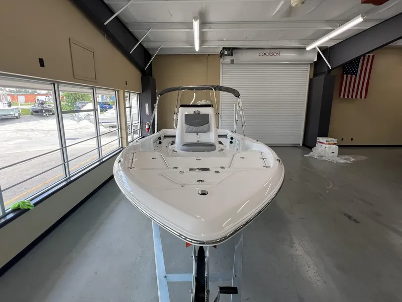 Slide: The Image of 2025 NauticStar 194 Bay boat displayed indoors, showcasing sleek design and modern features. - 13