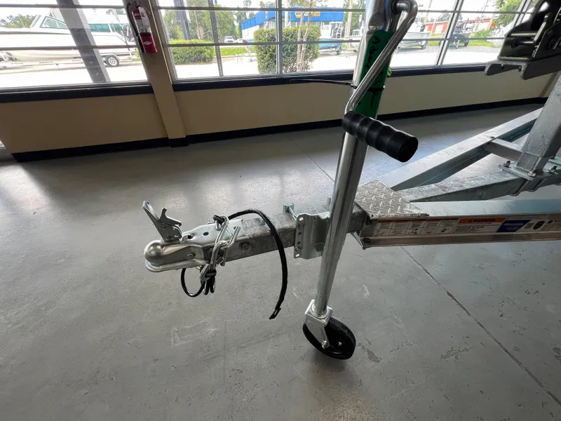 Slide: The Image of Trailer hitch of 2025 NauticStar 194 Bay boat in showroom. - 14