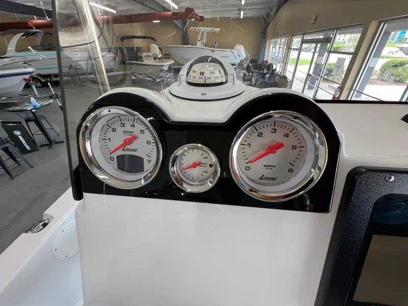 Slide: The Image of Dashboard of 2025 NauticStar 194 Bay boat with gauges and compass. - 16