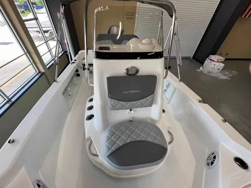 Slide: The Image of 2025 NauticStar 194 Bay boat interior with gray seating and modern console design. - 20