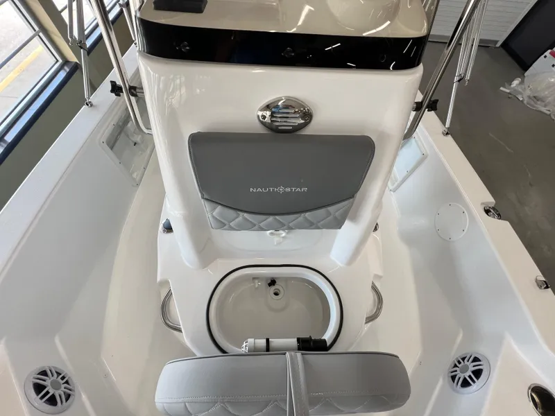 Slide: The Image of 2025 NauticStar 194 Bay boat interior with seating and storage features. - 21