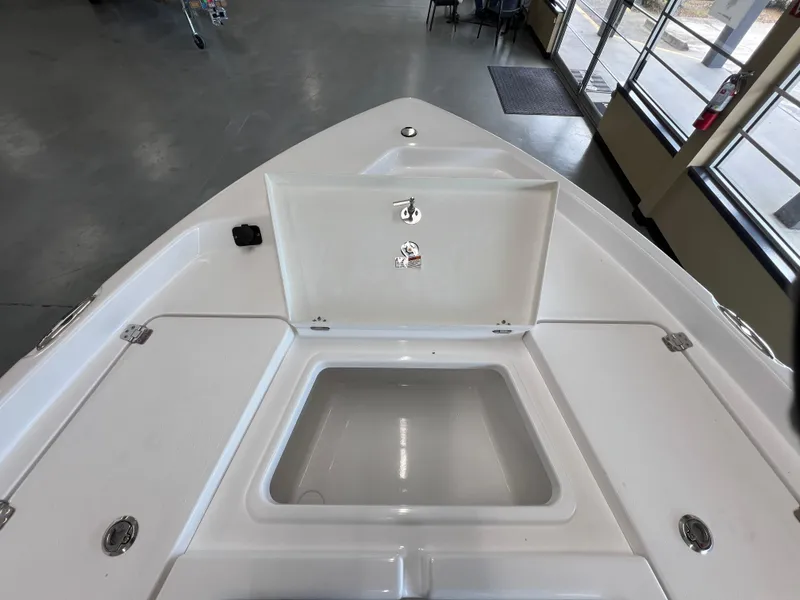 Slide: The Image of 2025 NauticStar 194 Bay boat interior with open storage compartment. - 26