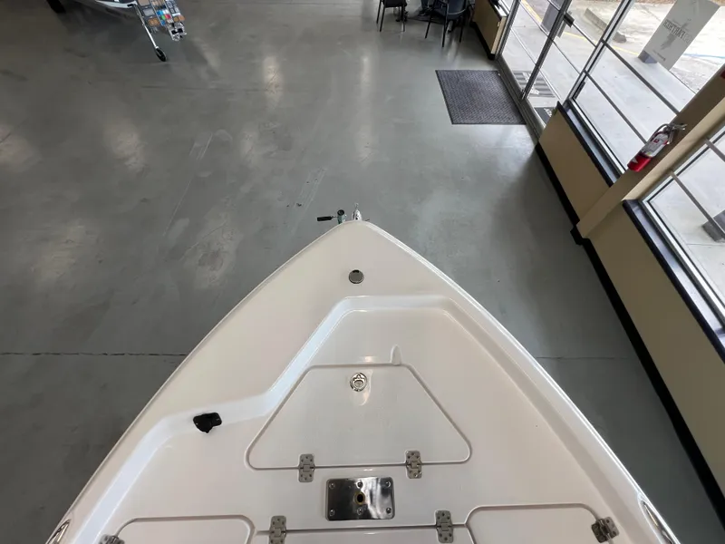 Slide: The Image of 2025 NauticStar 194 Bay boat bow in showroom, top view. - 29