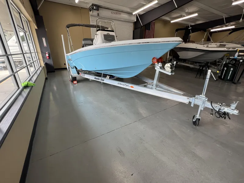Slide: The Image of 2025 NauticStar 194 Bay boat on trailer in showroom. - 3