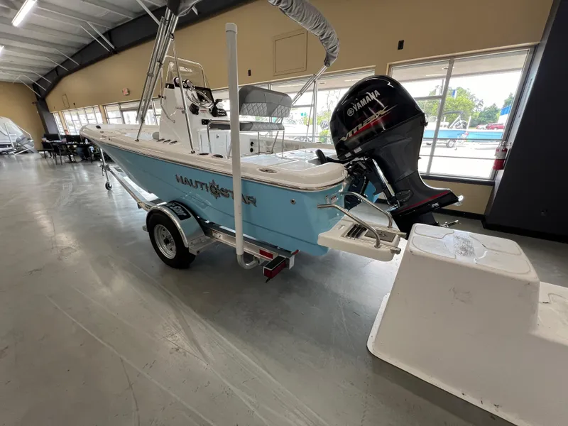 Slide: The Image of 2025 NauticStar 194 Bay boat with Yamaha engine in showroom. - 5