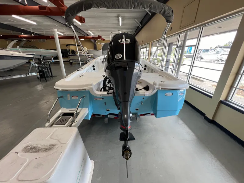 Slide: The Image of 2025 NauticStar 194 Bay boat with outboard motor in showroom. - 7