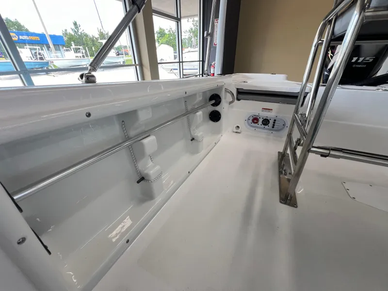 Slide: The Image of 2025 NauticStar 194 Bay boat interior with stainless steel ladder and control panel. - 8
