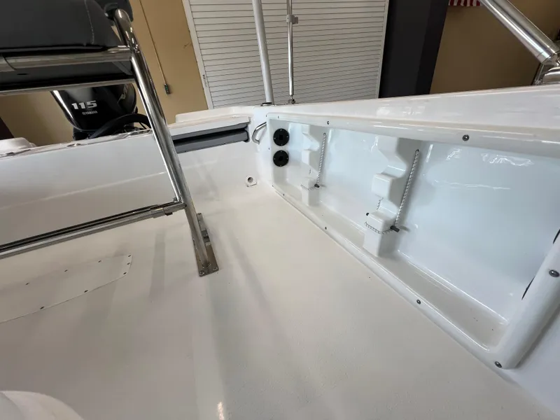 Slide: The Image of 2025 NauticStar 194 Bay boat interior, showcasing sleek white deck and seating area. - 9