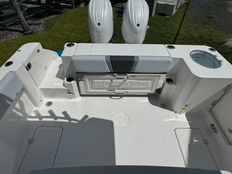 Slide: The Image of 2025 Robalo R270 Center Console boat deck with dual engines and storage compartments. - 10