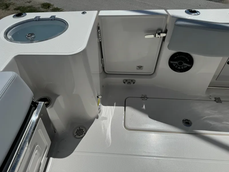 Slide: The Image of 2025 Robalo R270 Center Console boat interior with storage compartments and seating. - 13