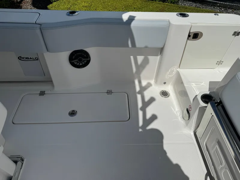 Slide: The Image of 2025 Robalo R270 Center Console boat interior, featuring seating and storage compartments. - 14