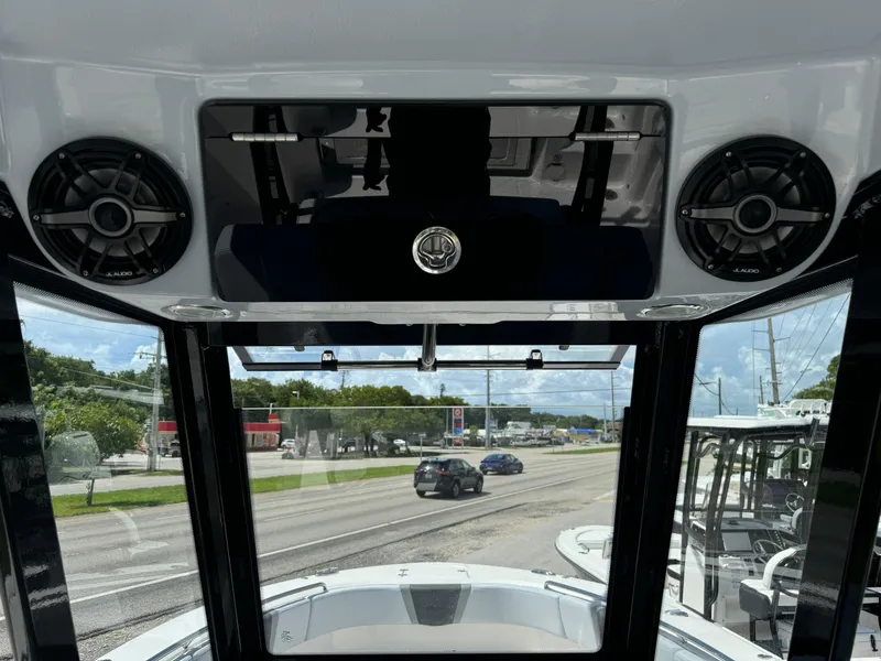 Slide: The Image of 2025 Robalo R270 Center Console interior view with speakers and windshield. - 17
