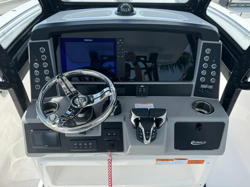 Slide: The Image of 2025 Robalo R270 Center Console dashboard with steering wheel and control panel. - 18