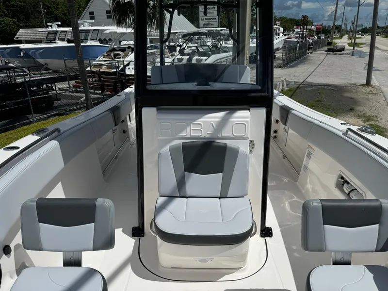 Slide: The Image of 2025 Robalo R270 Center Console boat interior with seating and console view. - 28