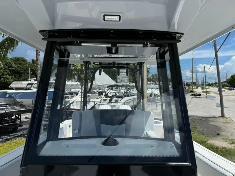Slide: The Image of 2025 Robalo R270 Center Console boat, front view with windshield and seating. - 31