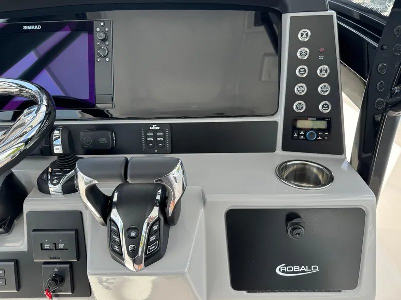 Slide: The Image of 2025 Robalo R270 Center Console dashboard with controls and display screen. - 32