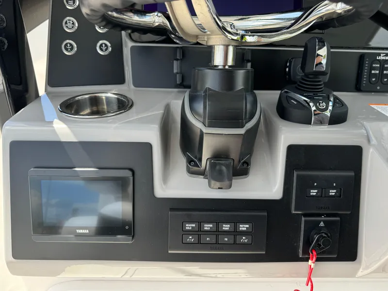 Slide: The Image of 2025 Robalo R270 Center Console dashboard with controls and display screen. - 35