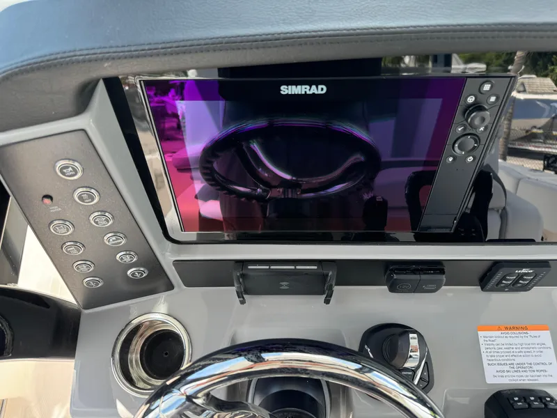Slide: The Image of 2025 Robalo R270 Center Console dashboard with Simrad display and controls. - 36