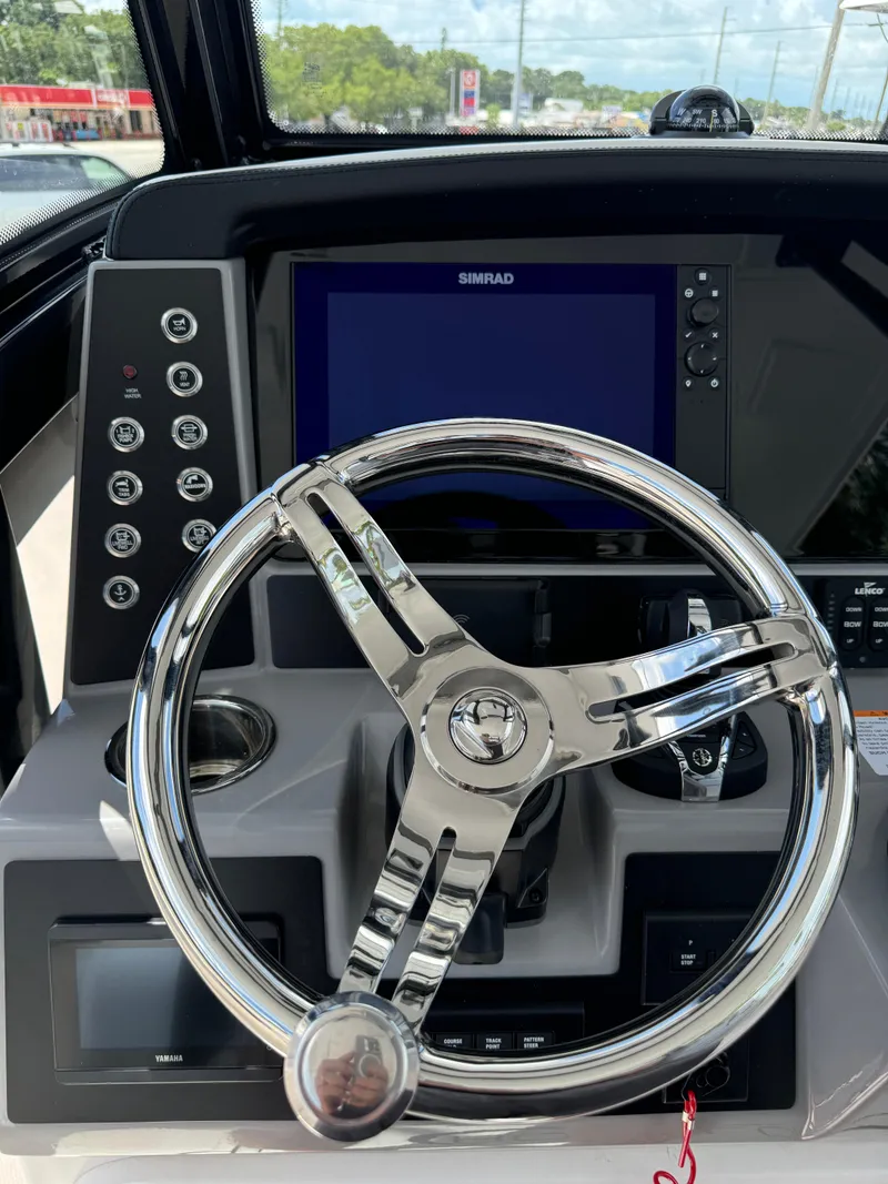 Slide: The Image of 2025 Robalo R270 Center Console helm with modern controls and sleek steering wheel. - 37
