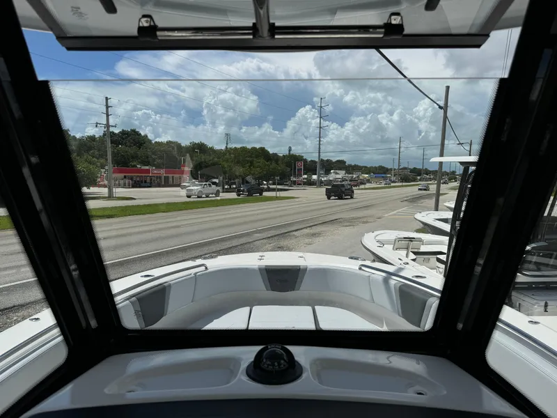 Slide: The Image of 2025 Robalo R270 Center Console boat view from cockpit, overlooking a busy road. - 38