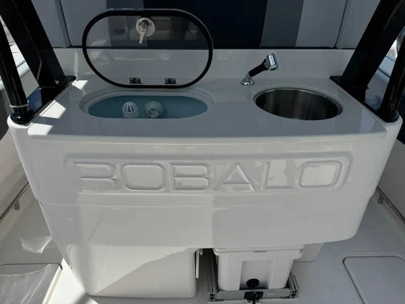 Slide: The Image of 2025 Robalo R270 Center Console boat sink and storage area. - 8