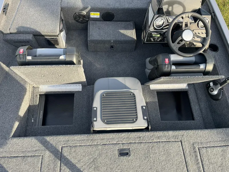 Slide: The Image of 2025 Lowe Stinger 175C boat interior with steering wheel and storage compartments. - 10