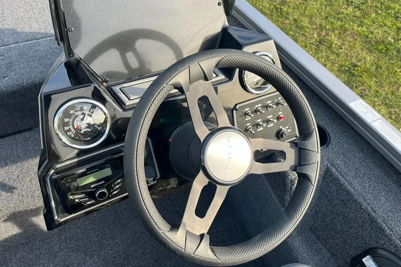 Slide: The Image of 2025 Lowe Stinger 175C boat dashboard with steering wheel and control panel. - 11