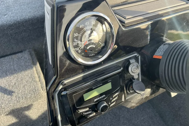 Slide: The Image of Dashboard of 2025 Lowe Stinger 175C boat with speedometer and audio system. - 12