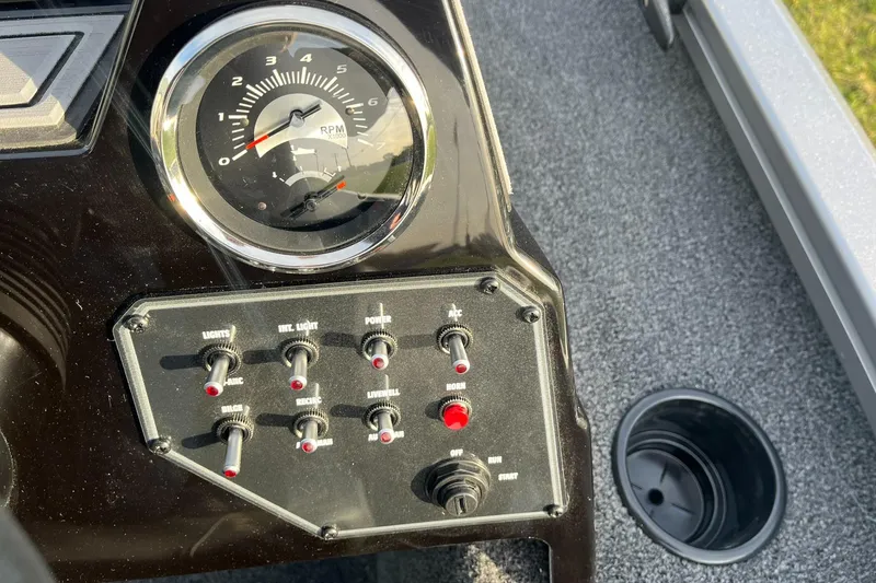 Slide: The Image of Dashboard of 2025 Lowe Stinger 175C boat with control switches and RPM gauge. - 13