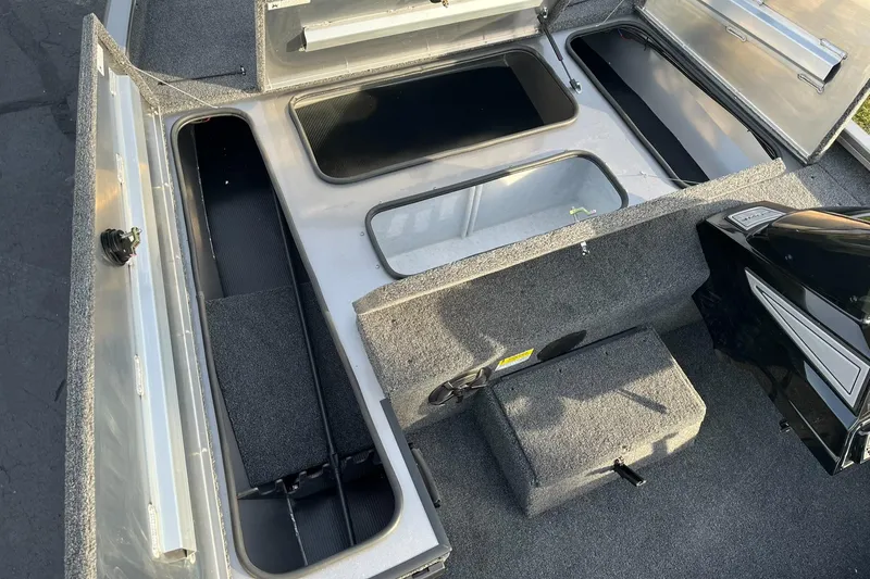 Slide: The Image of 2025 Lowe Stinger 175C boat interior with open storage compartments. - 14