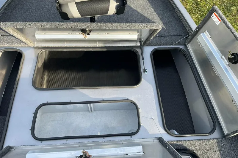 Slide: The Image of 2025 Lowe Stinger 175C boat storage compartments open, showcasing ample space and organization. - 15