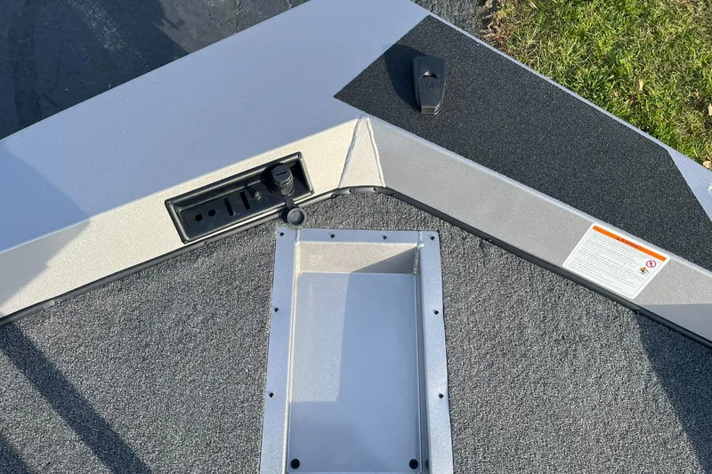 Slide: The Image of 2025 Lowe Stinger 175C boat deck with storage compartment and control panel. - 16