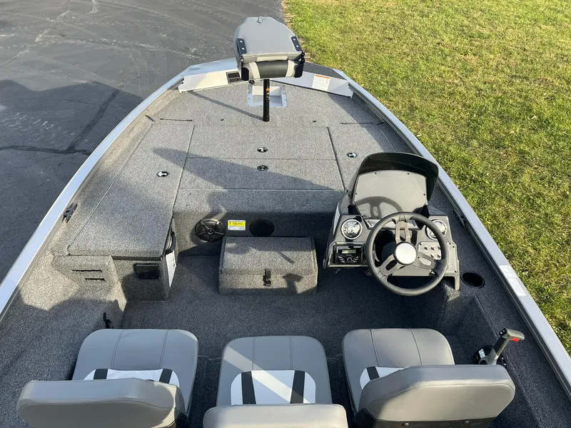 Slide: The Image of 2025 Lowe Stinger 175C fishing boat interior with steering console and seating. - 5