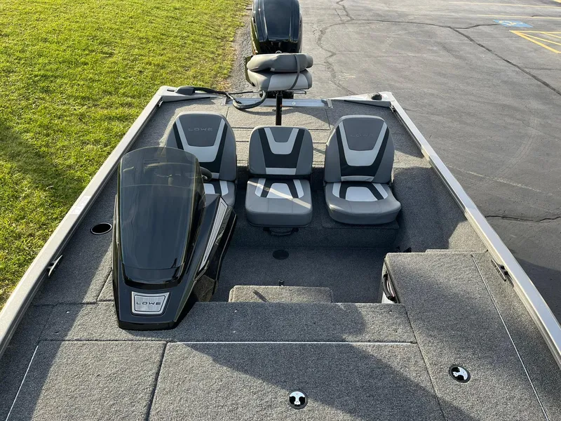 Slide: The Image of 2025 Lowe Stinger 175C fishing boat interior with three seats and motor. - 6