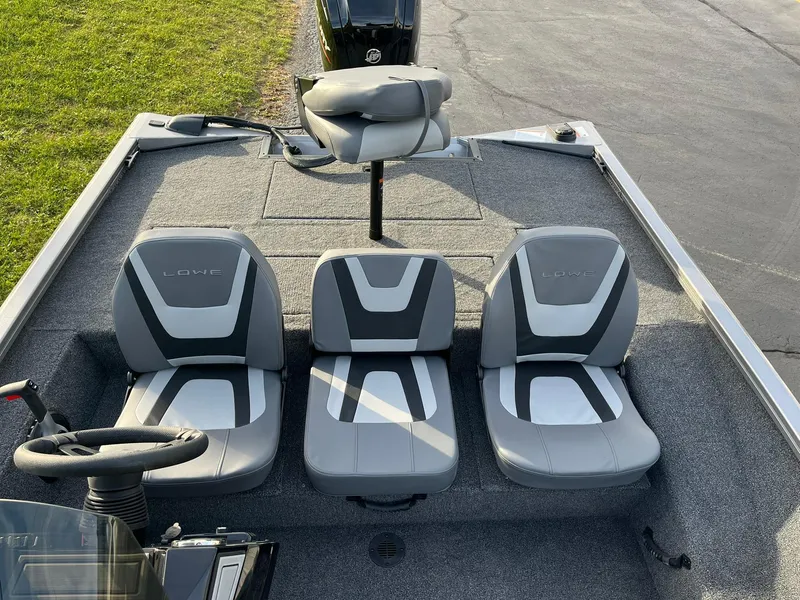 Slide: The Image of 2025 Lowe Stinger 175C boat interior with three gray seats. - 7
