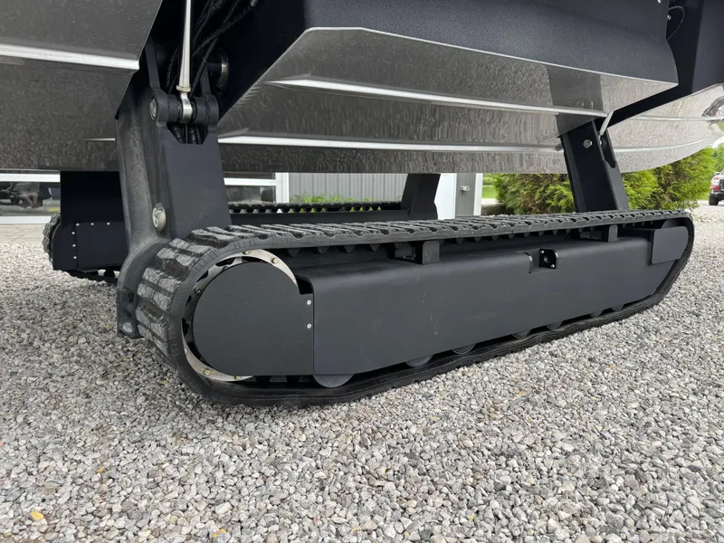 Slide: The Image of 2025 Iguana Bow Rider amphibious boat with track system on gravel surface. - 10