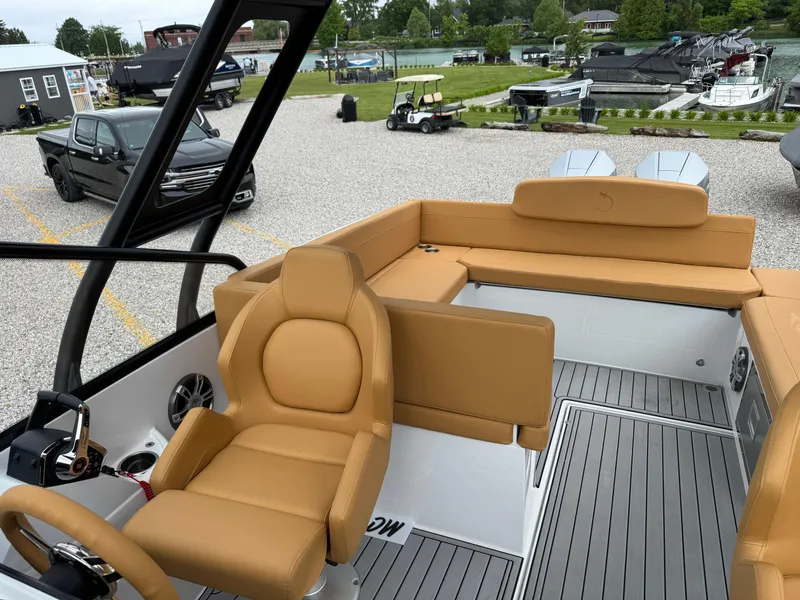 Slide: The Image of 2025 Iguana Bow Rider boat with tan leather seating and modern interior design. - 13
