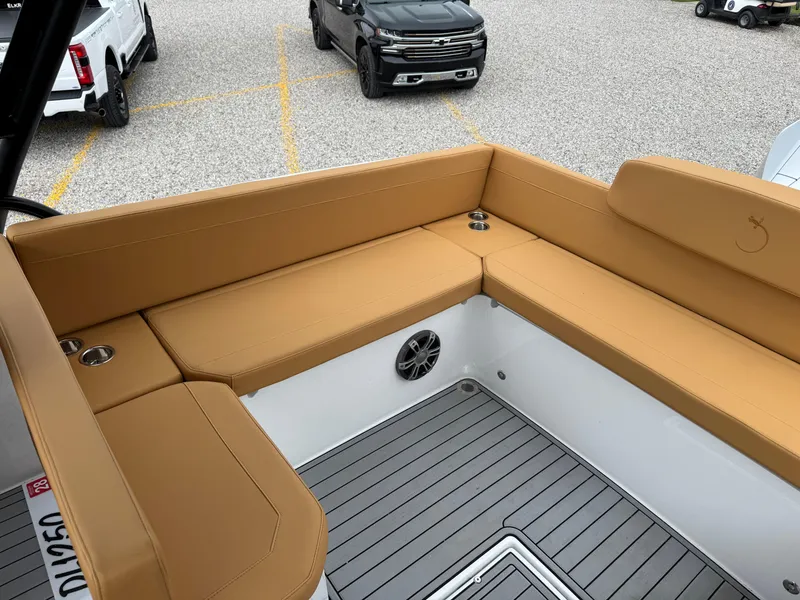 Slide: The Image of 2025 Iguana Bow Rider boat interior with tan seating and gray flooring. - 14