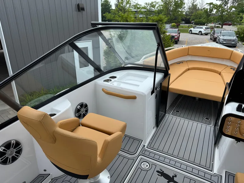 Slide: The Image of 2025 Iguana Bow Rider boat interior with tan seating and modern design. - 18
