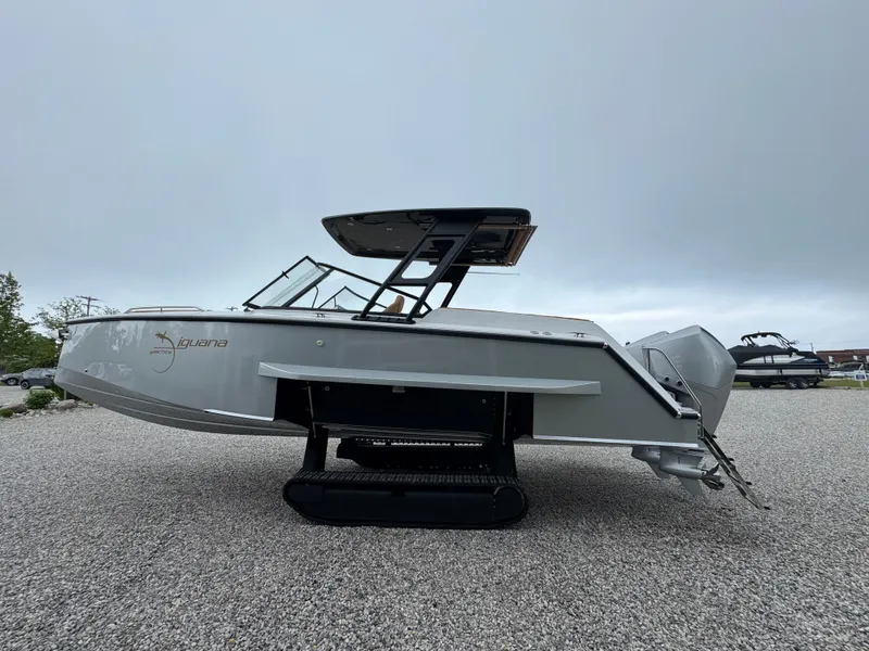 Slide: The Image of 2025 Iguana Bow Rider boat with innovative track system on gravel surface. - 6
