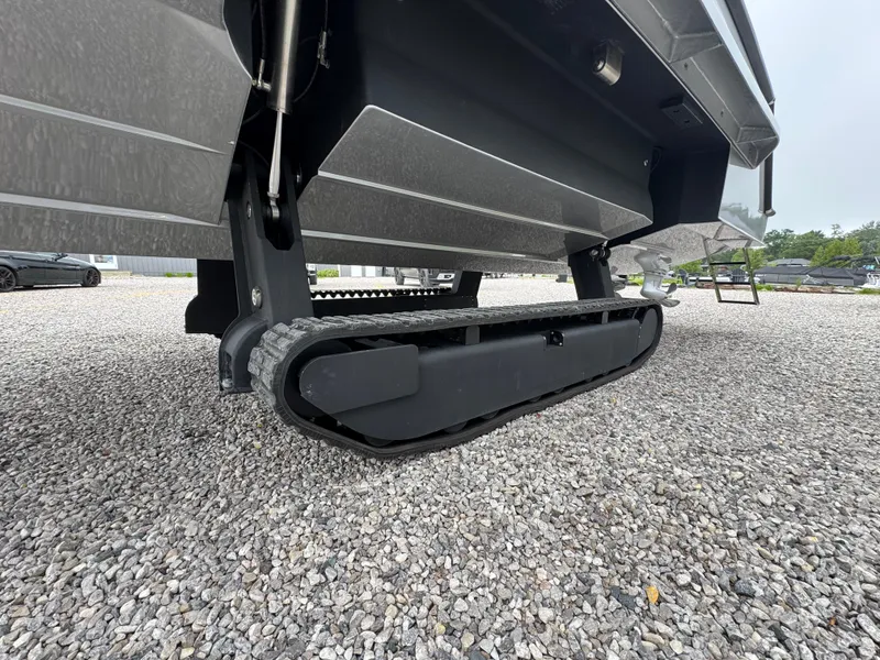 Slide: The Image of 2025 Iguana Bow Rider with amphibious track system on gravel surface. - 9