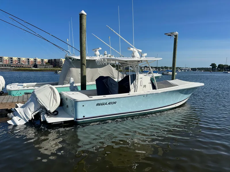 The Image of 2018 Regulator 28 boat docked in a marina, clear blue sky. - 0