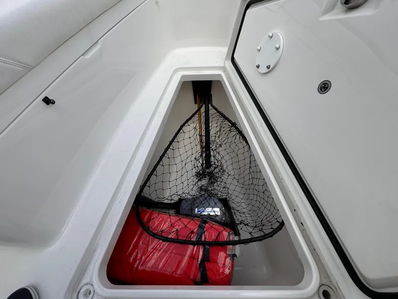 Slide: The Image of Storage compartment in 2018 Regulator 28 boat with fishing net and red bag. - 11