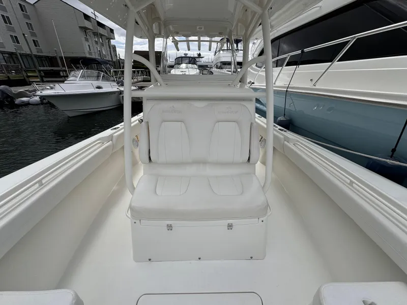 Slide: The Image of 2018 Regulator 28 boat interior with white seating, docked at marina. - 13