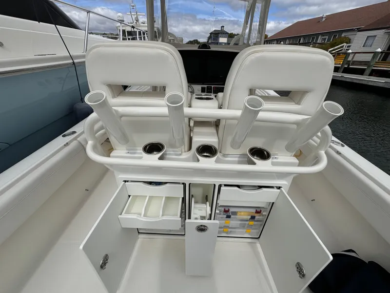 Slide: The Image of 2018 Regulator 28 boat interior with rod holders and storage compartments. - 19