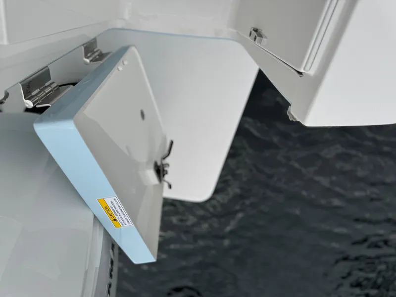 Slide: The Image of 2018 Regulator 28 boat compartment open above water. - 22